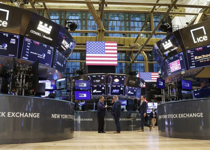Traders work on the floor of the New York Stock Exchange on Wall Street in New York City in 2022