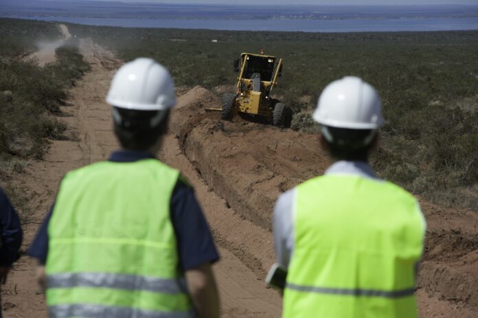 Workers at a gas pipeline construction in Vaca Muerta oil field in Neuquén, Argentina