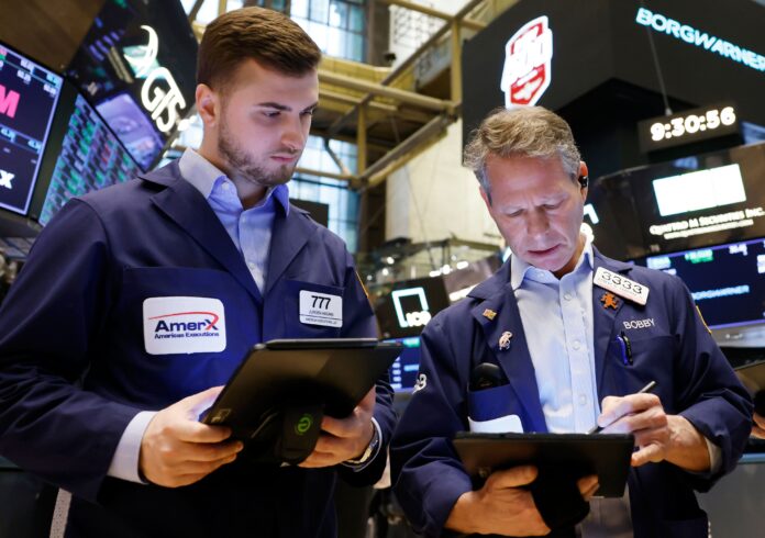 Traders work on the floor of the New York Stock Exchange on Wall Street in February 2024
